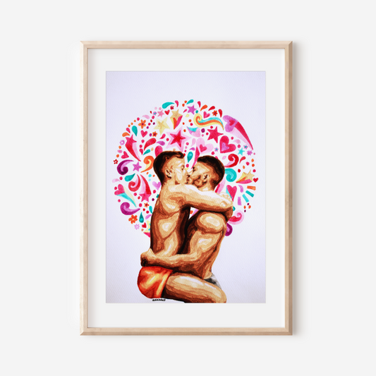 Framed artwork of two people embracing with a colorful heart design on a white wall.