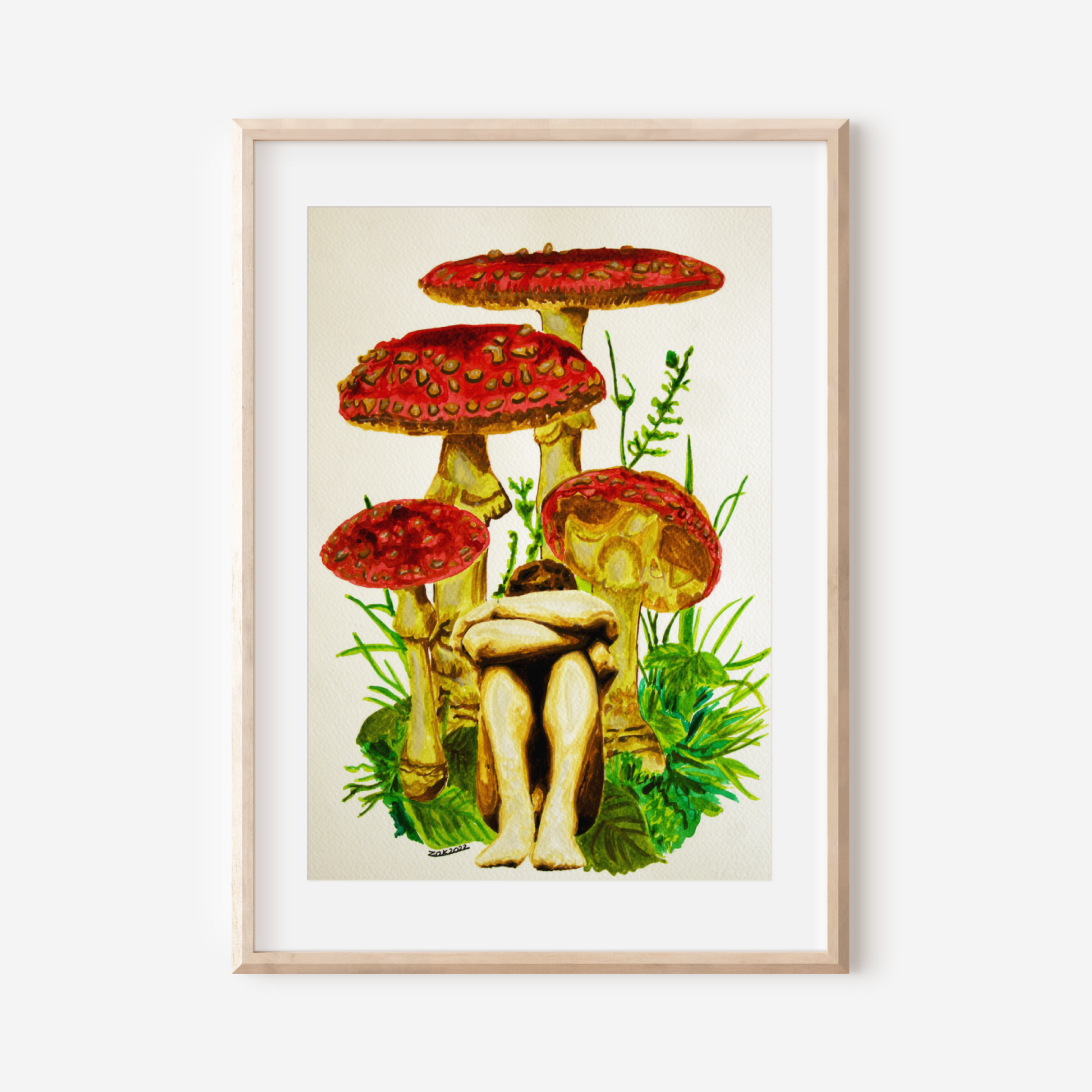 Framed artwork of mushrooms with a person sitting on one, on a white wall.