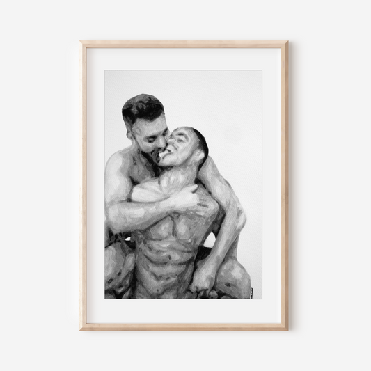 Framed black and white photograph of two people embracing on a white wall.