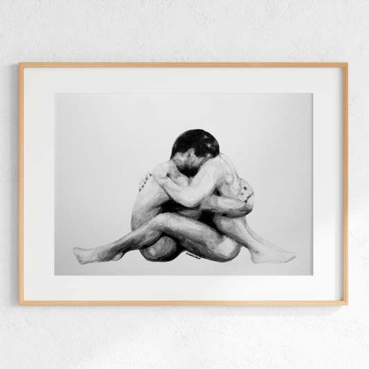 Framed black and white artwork of two people embracing on a light gray background