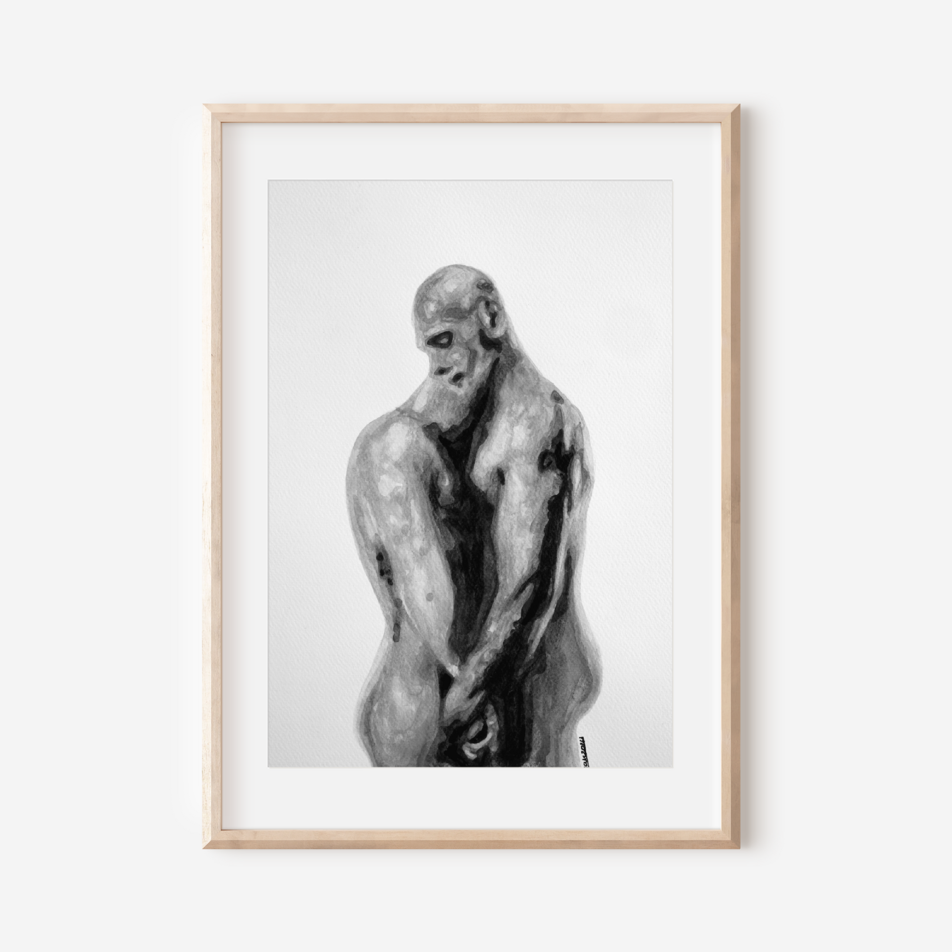 Framed black and white artwork of a muscular figure on a white wall