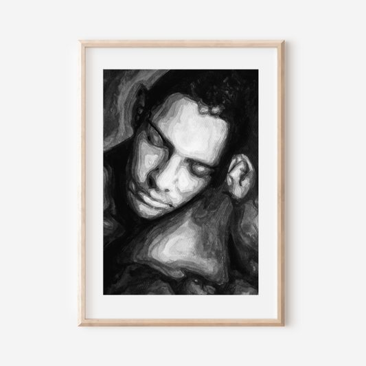 Framed black and white portrait of a person on a white wall