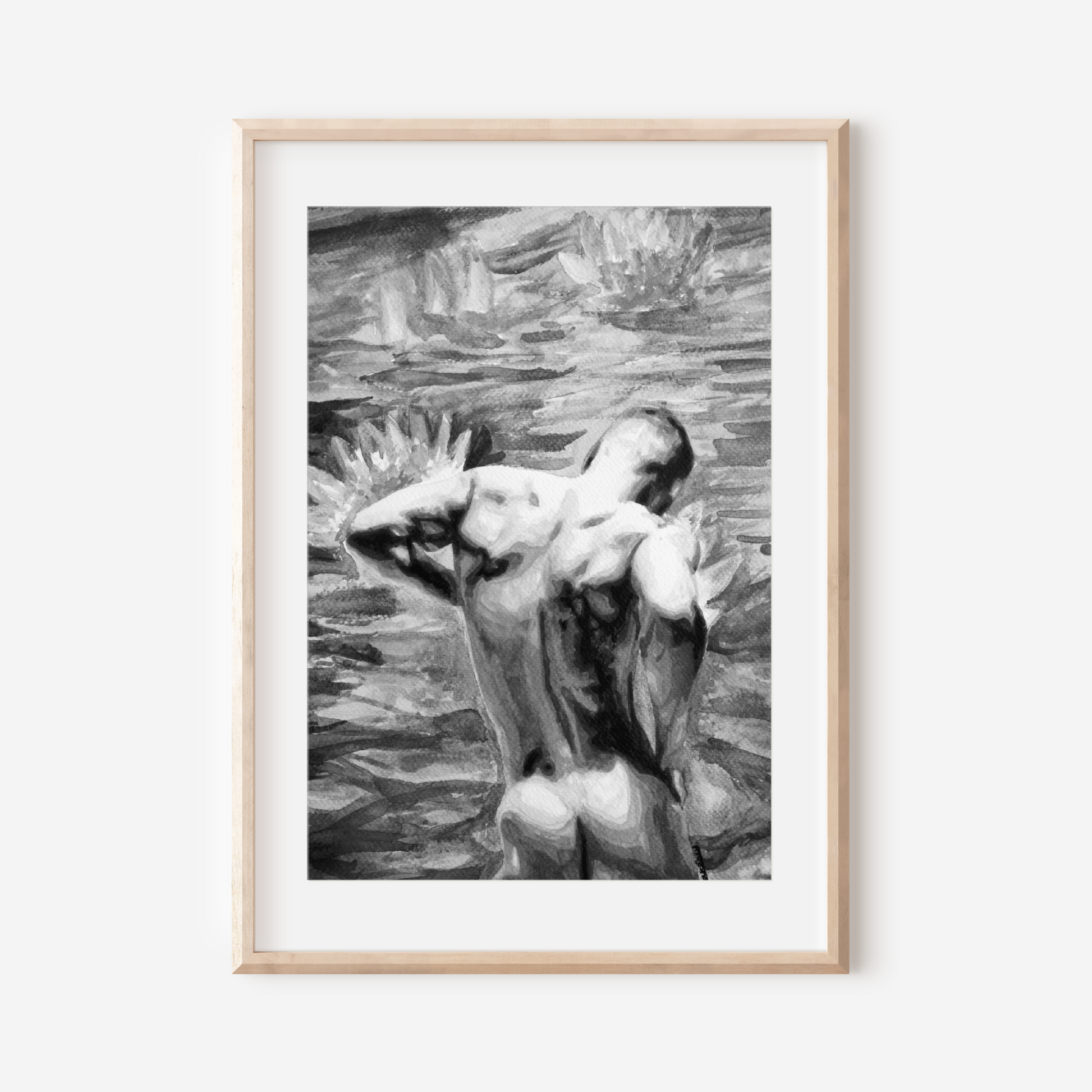 Framed black and white artwork of a nude figure on a white wall