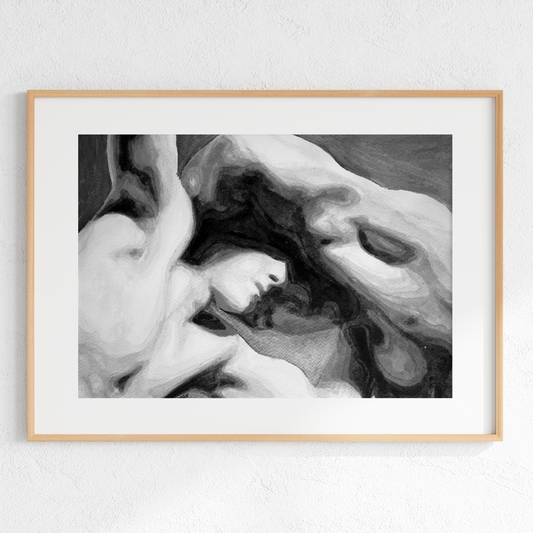 Framed artwork of a black and white abstract design on a light gray wall.