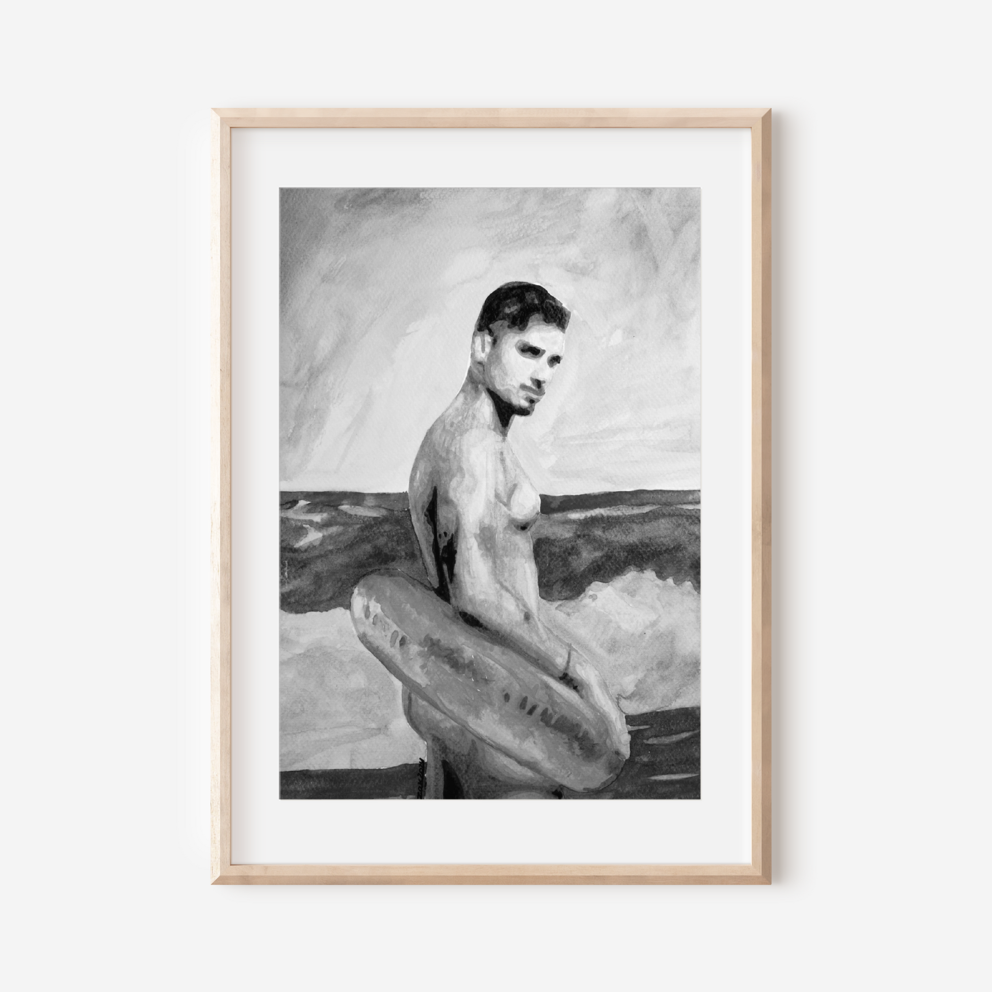 Framed black and white artwork of a man with a surfboard on a white wall