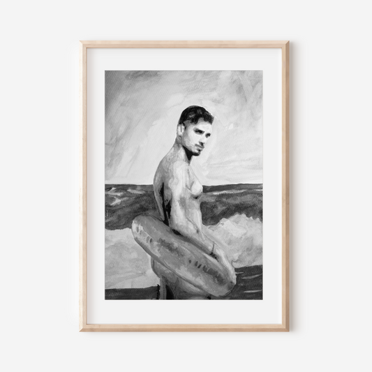 Framed black and white artwork of a man with a surfboard on a white wall