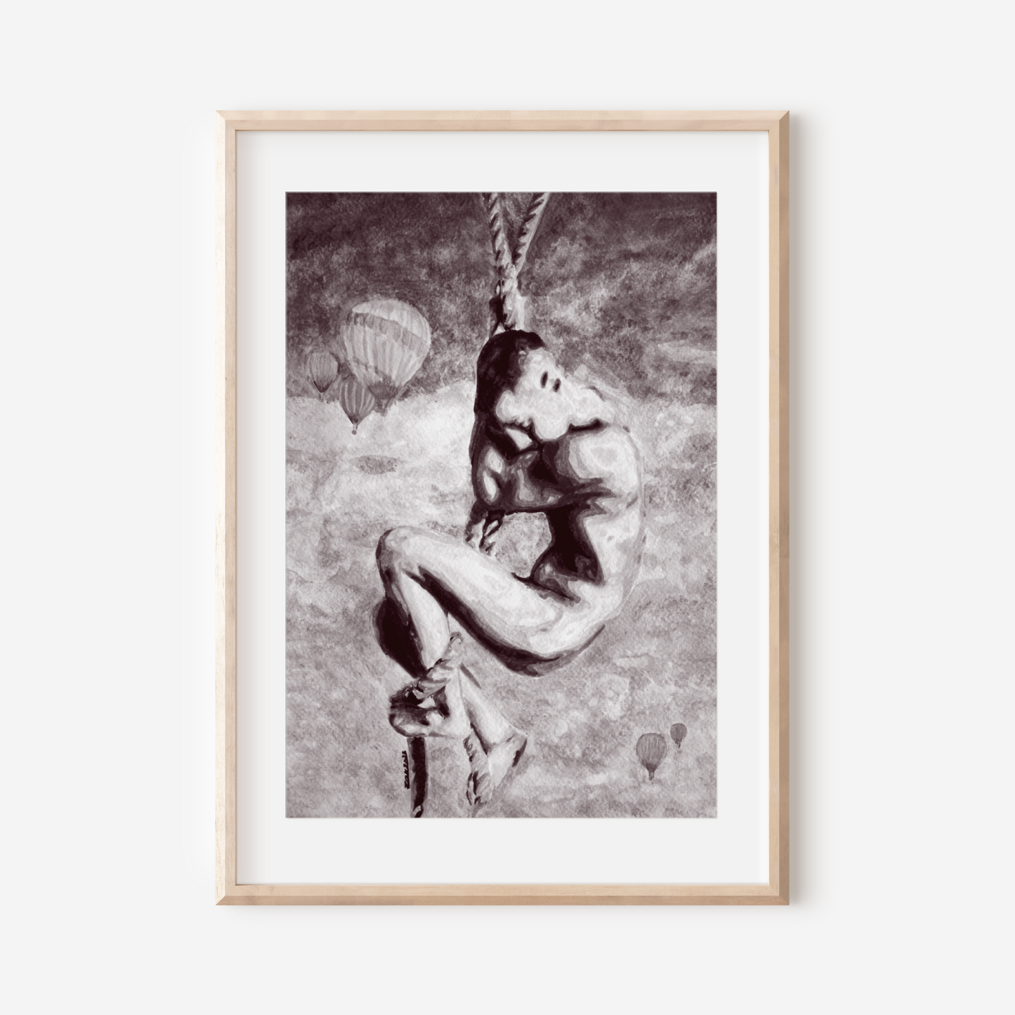 Framed black and white artwork of a person on a rope against a light background