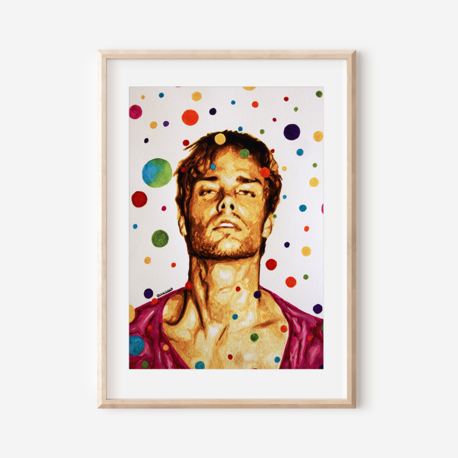 Framed artwork of a person with colorful polka dots on a white wall