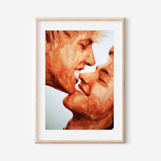 Framed artwork of two faces close together on a white wall
