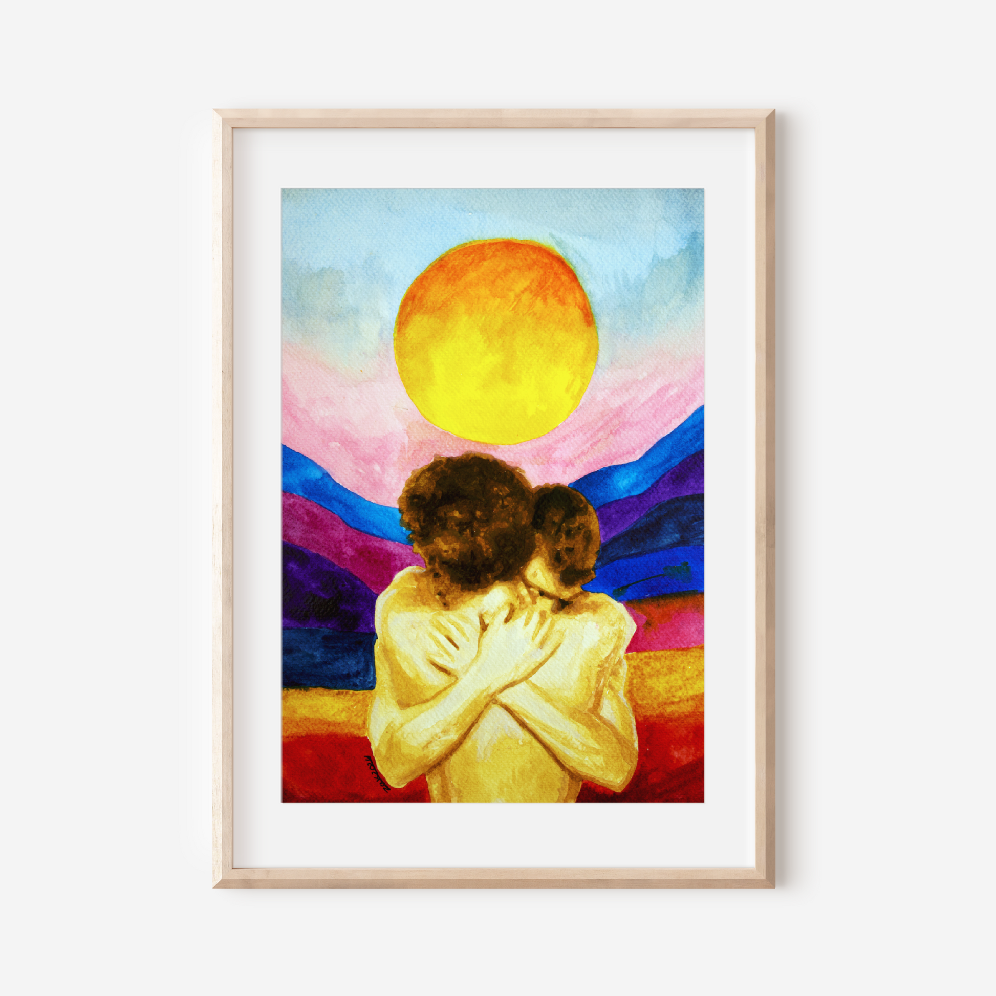 Framed artwork of two people embracing with a colorful sunset background.