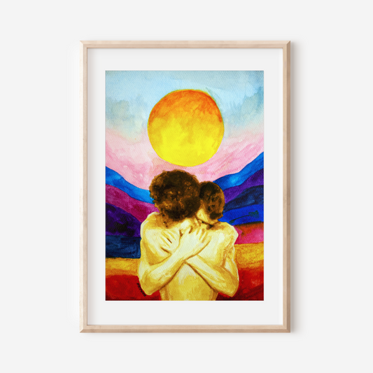 Framed artwork of two people embracing with a colorful sunset background.