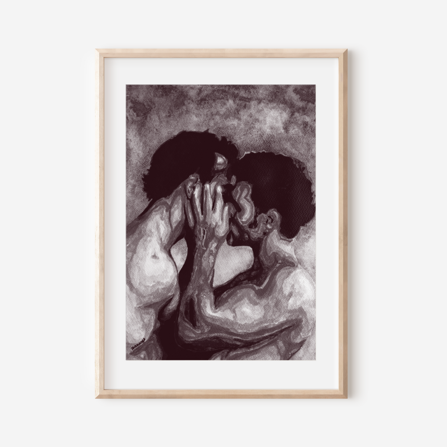 Framed artwork of two figures embracing on a white wall