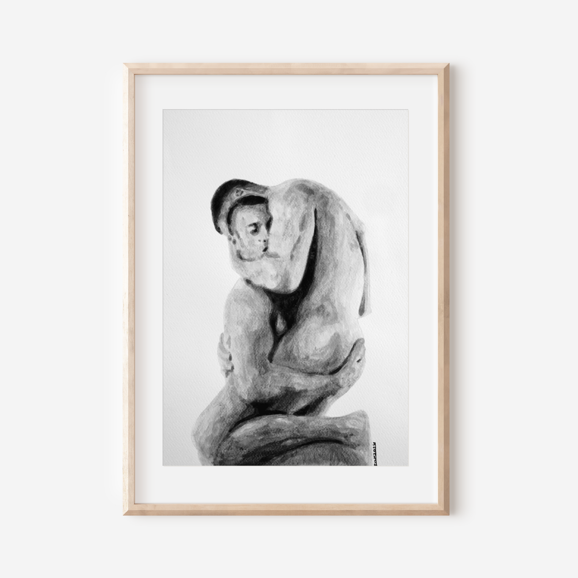 Framed black and white artwork of a nude figure on a white wall