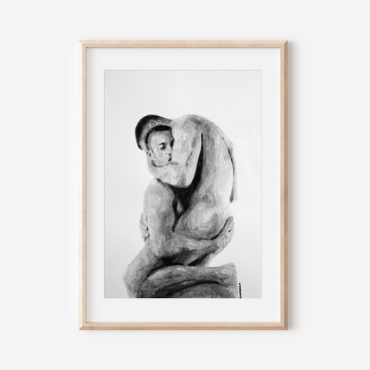 Framed black and white artwork of a nude figure on a white wall