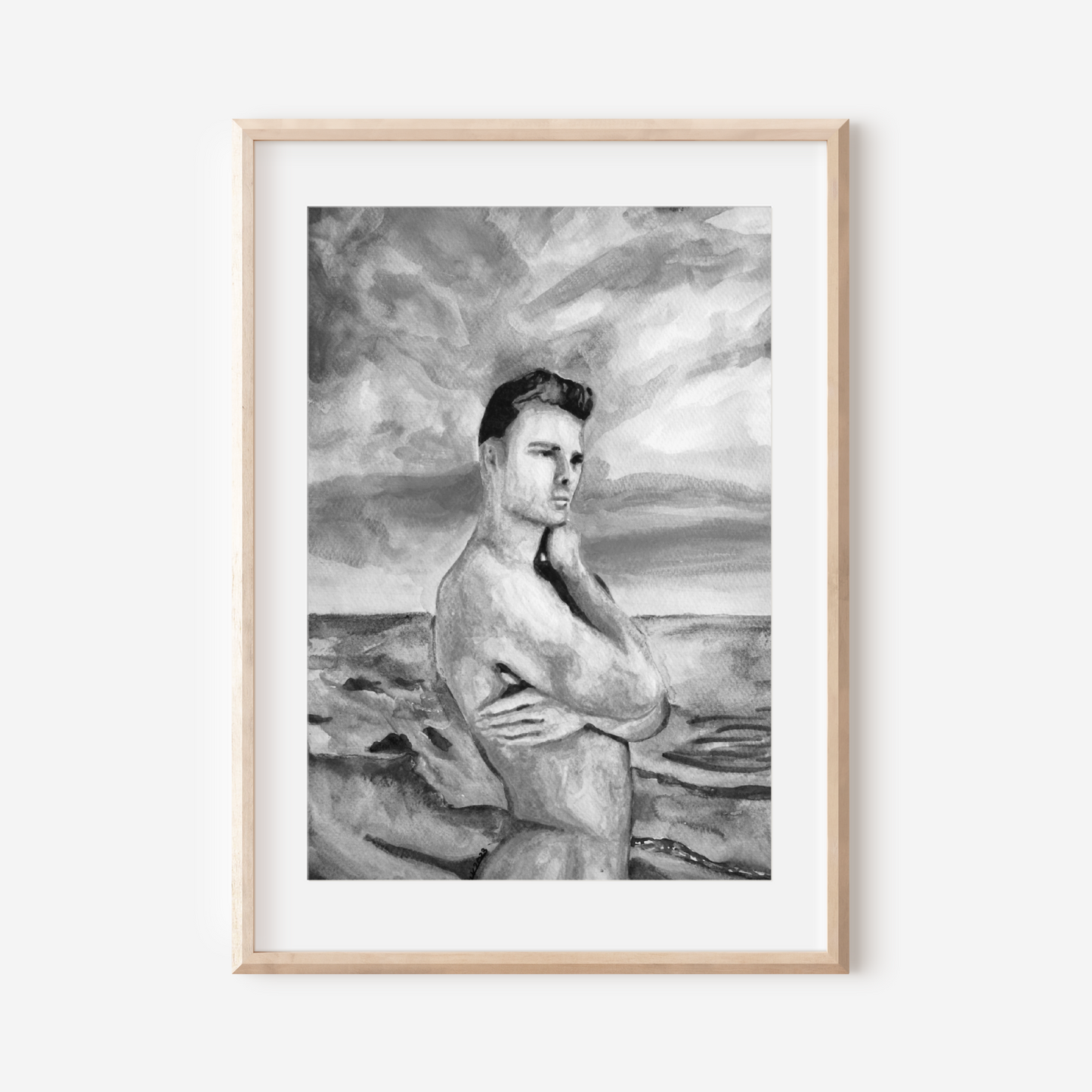Framed black and white artwork of a nude figure on a beach.