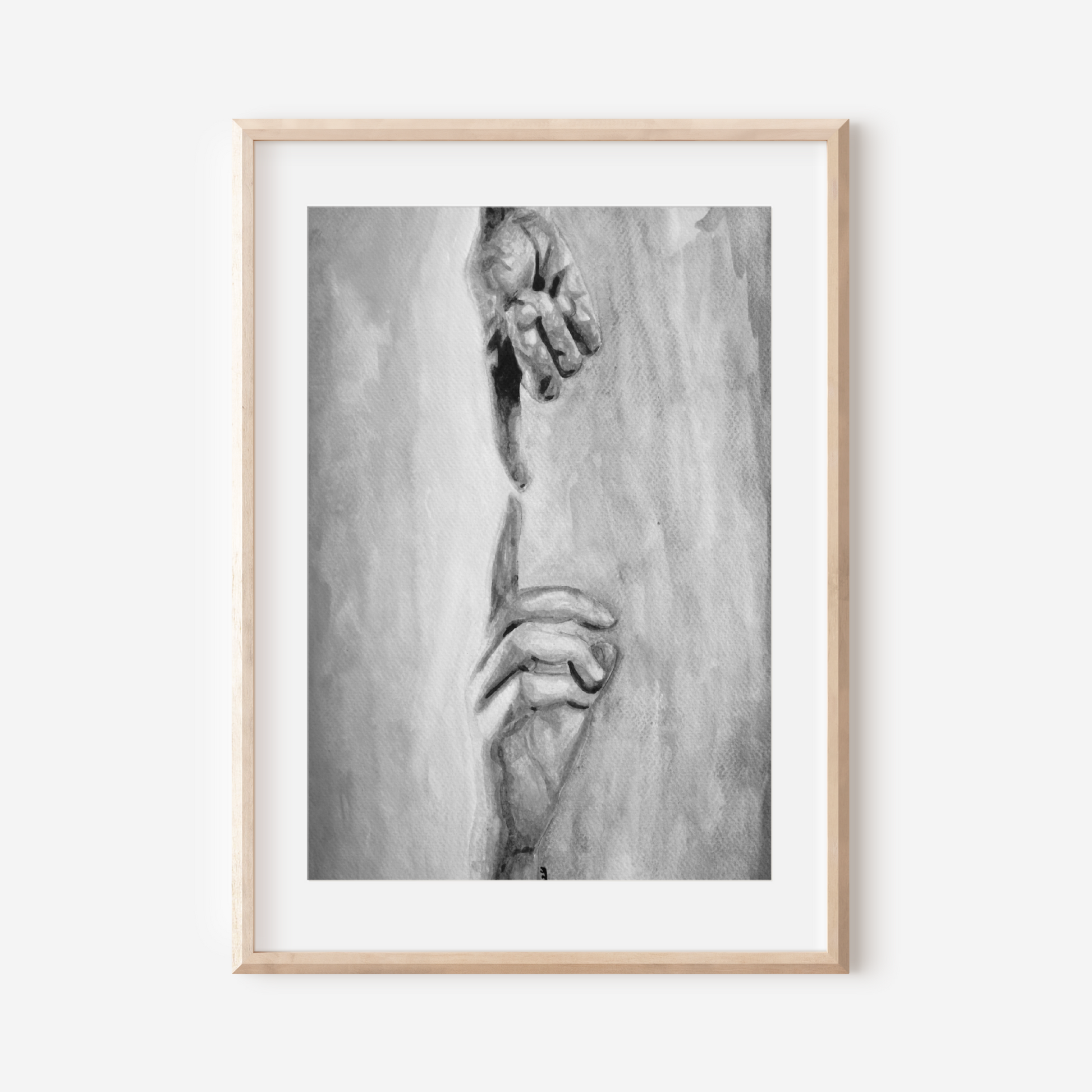 Framed black and white artwork of a hand on a white wall