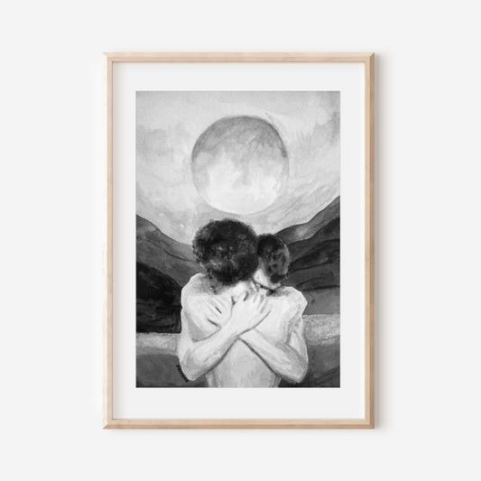 Framed artwork of two people embracing with a large moon in the sky on a white wall.