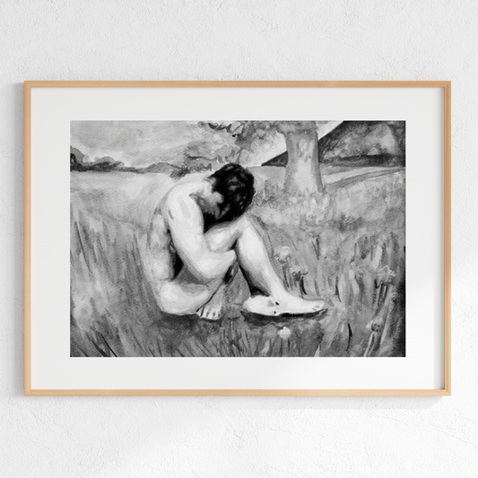 Framed black and white artwork of a nude figure sitting on the ground.