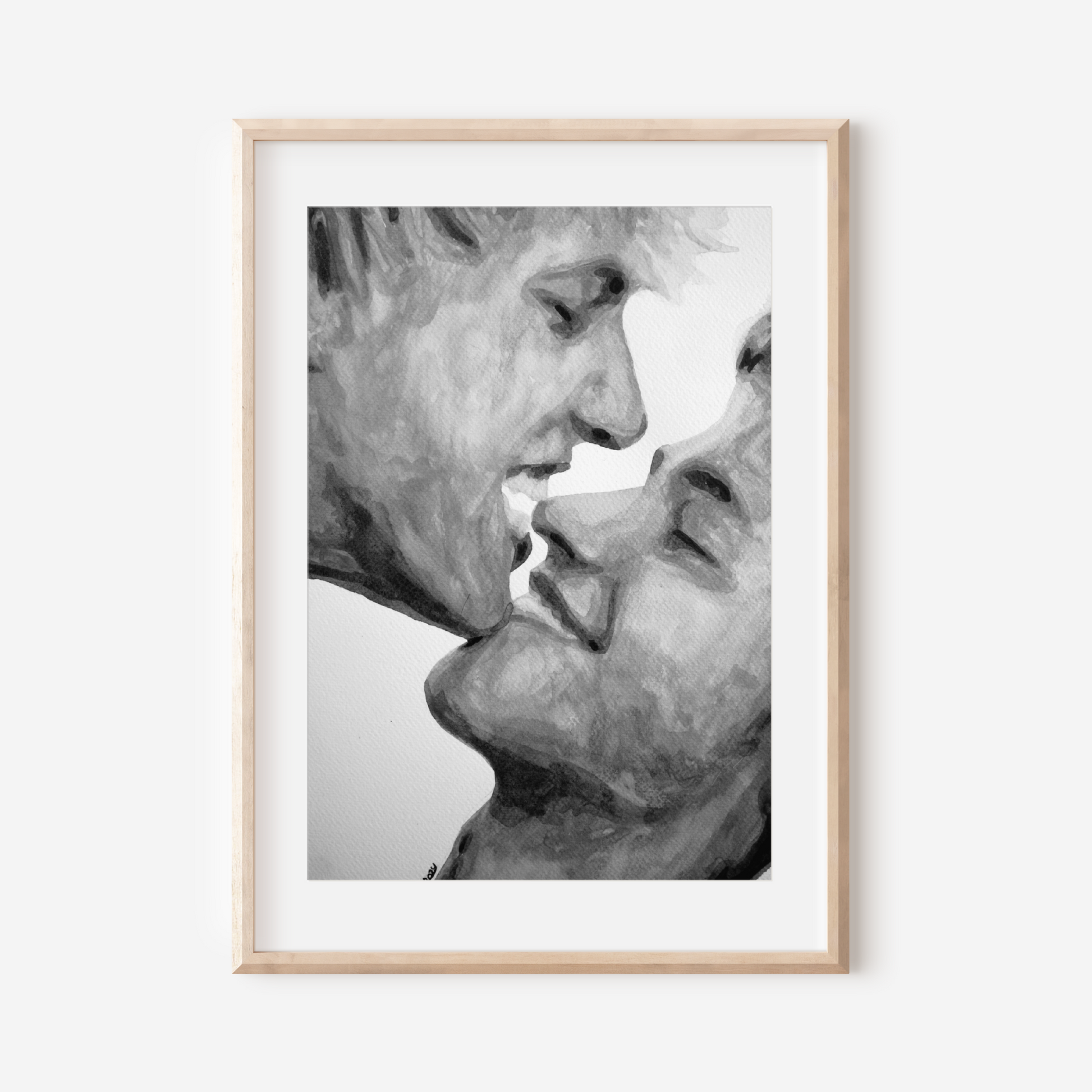 Framed black and white artwork of two faces close together on a white background