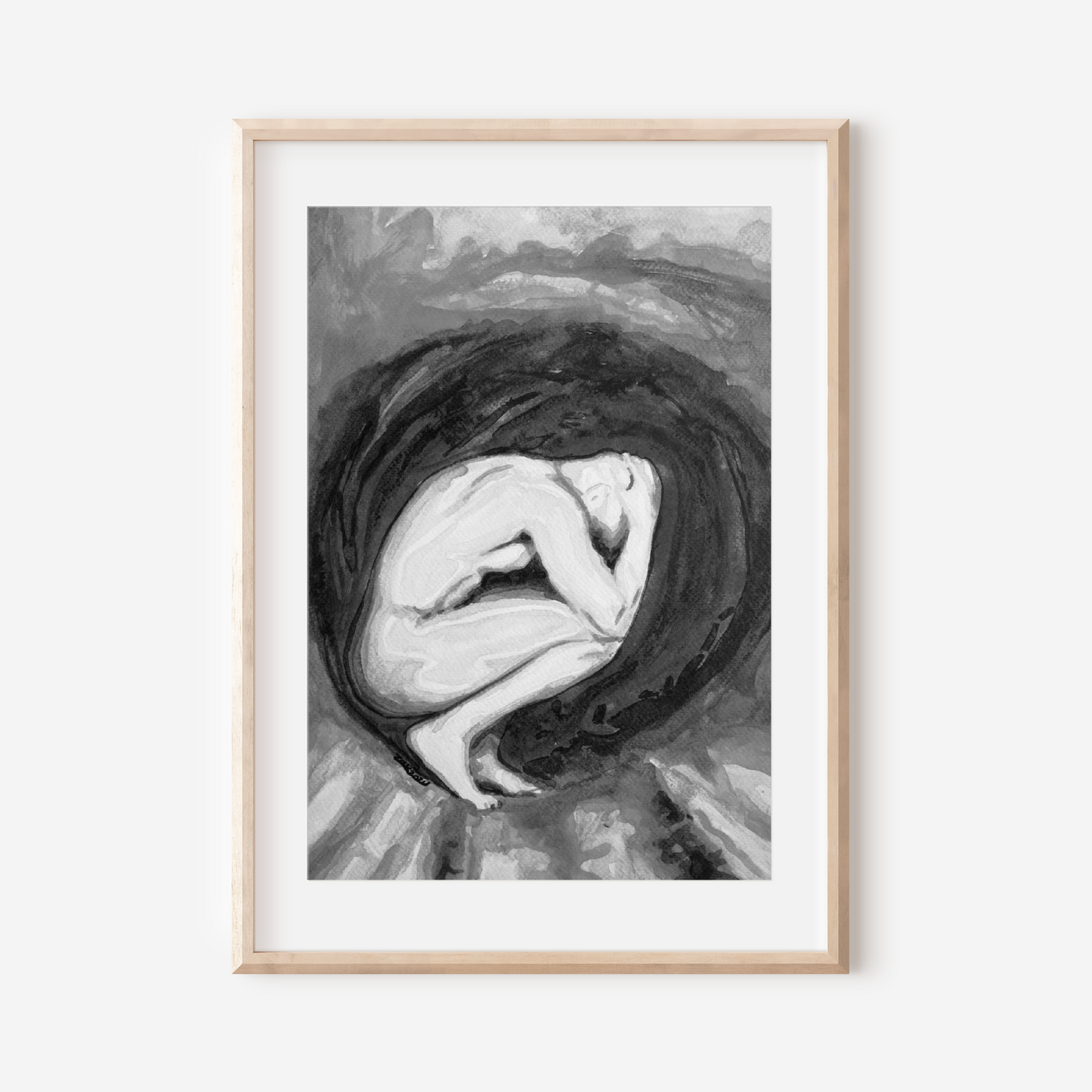 Framed black and white artwork of a woman with her head in her hands on a white background