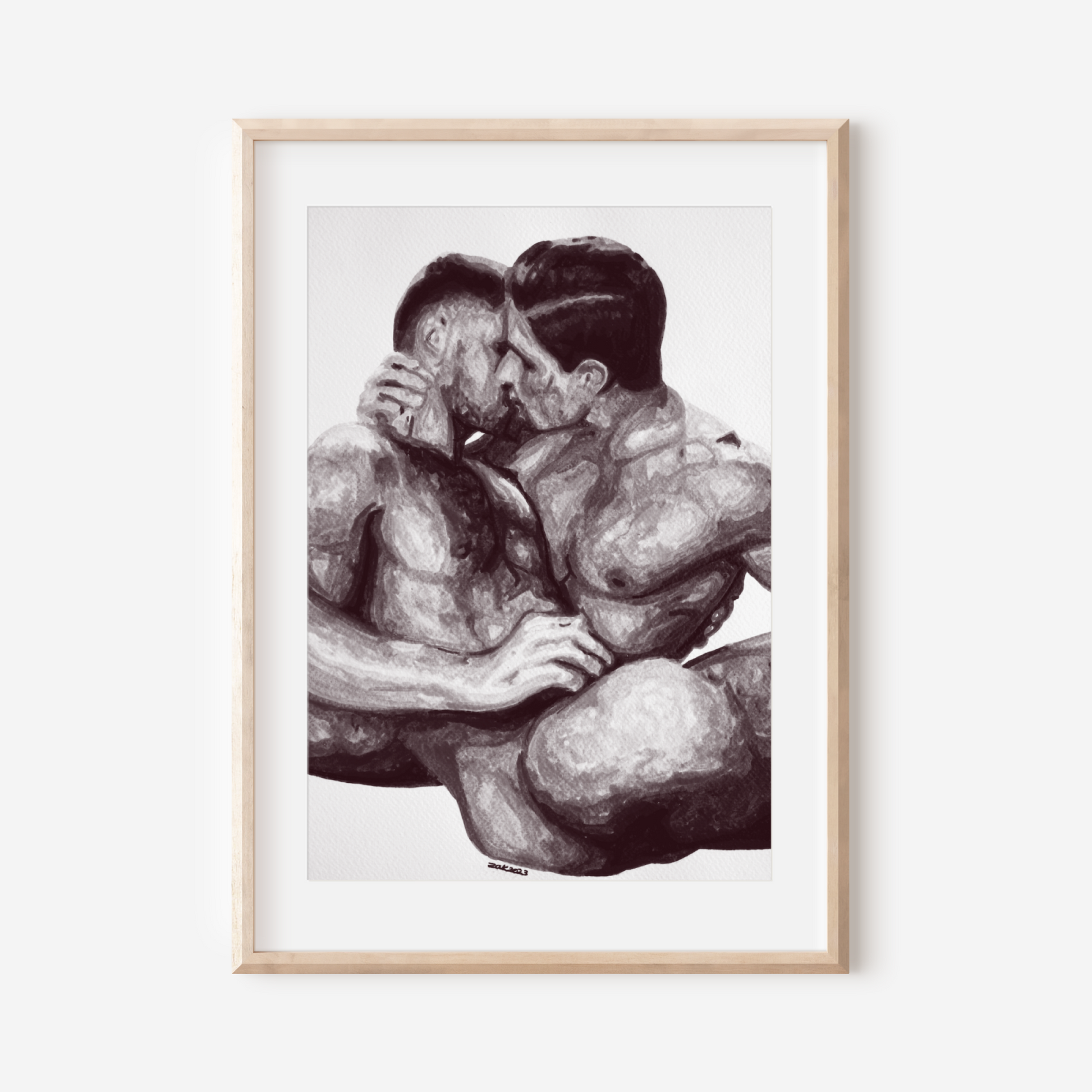 Framed artwork of two people embracing on a white wall