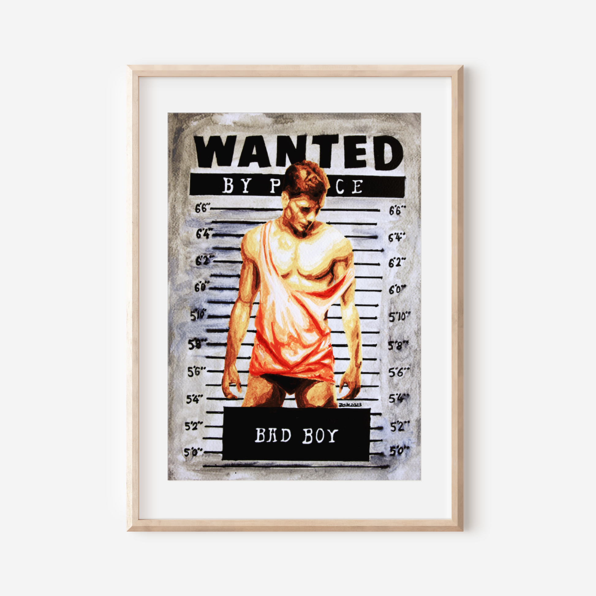 Framed poster with a 'Wanted' design featuring a shirtless person, on a white wall.