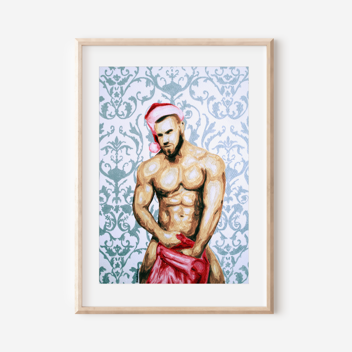 Framed artwork of a shirtless man wearing a Santa hat and red pants on a decorative patterned background.
