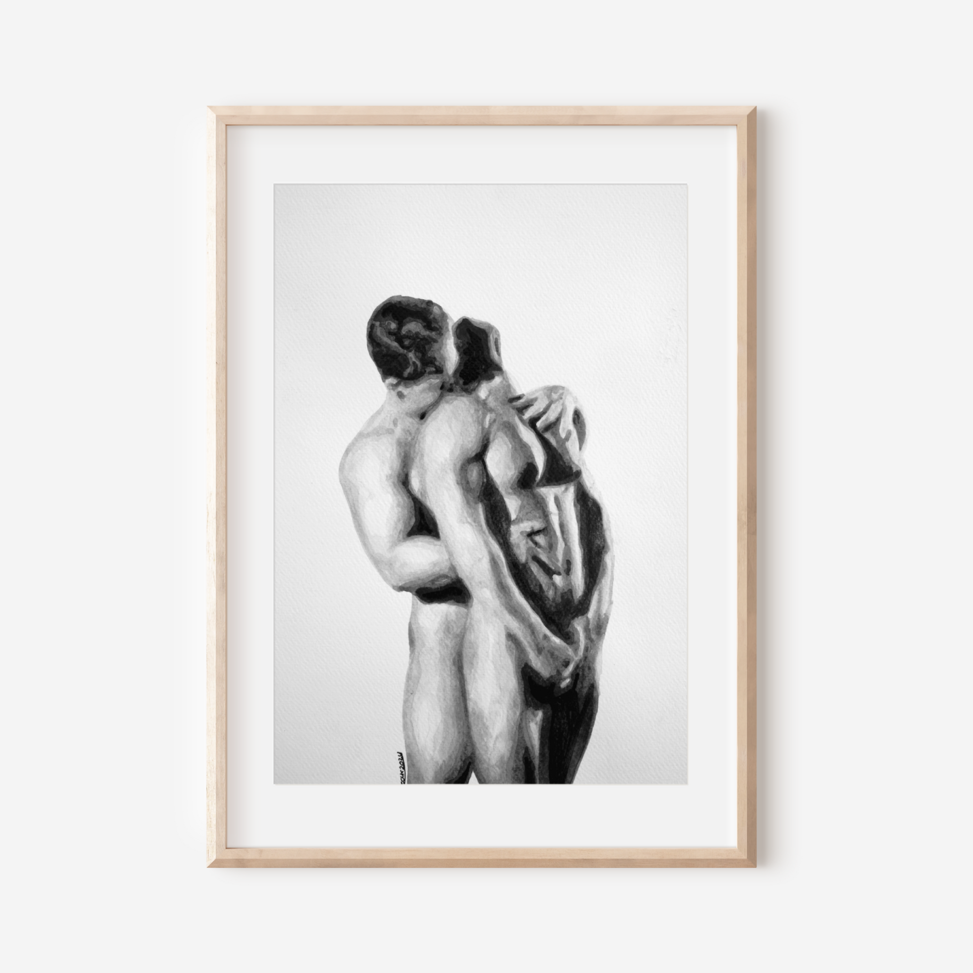 Framed black and white artwork of two nude figures embracing on a white background