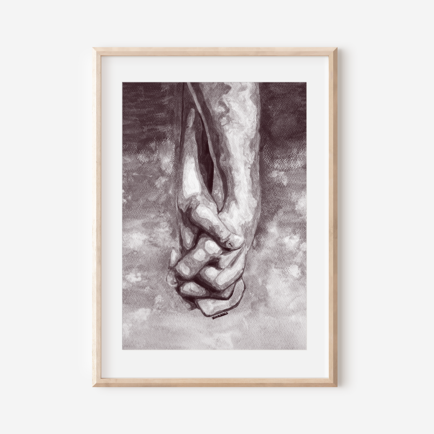 Framed artwork of a hand holding a foot on a white wall
