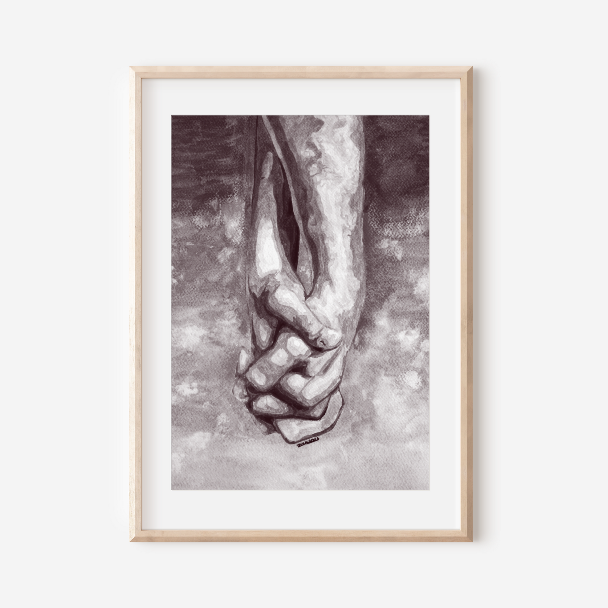 Framed artwork of a hand holding a foot on a white wall