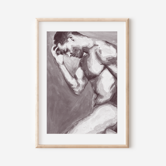 Framed black and white artwork of a nude figure on a white wall