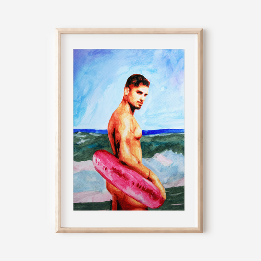 Framed artwork of a man with a pink inner tube against a beach background