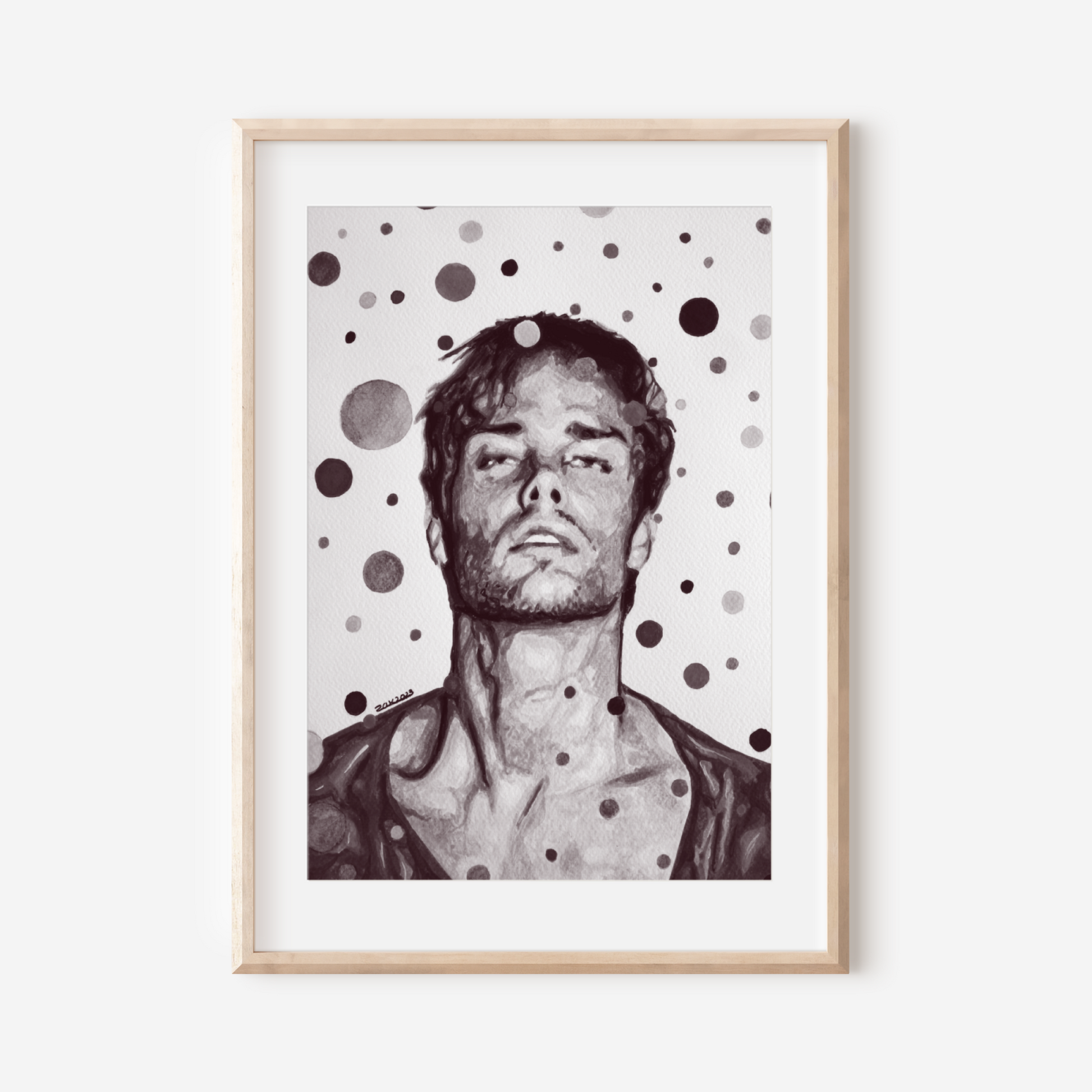 Framed artwork of a man with polka dot pattern on a white wall