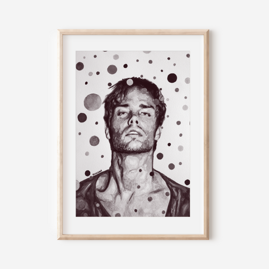 Framed artwork of a man with polka dot pattern on a white wall