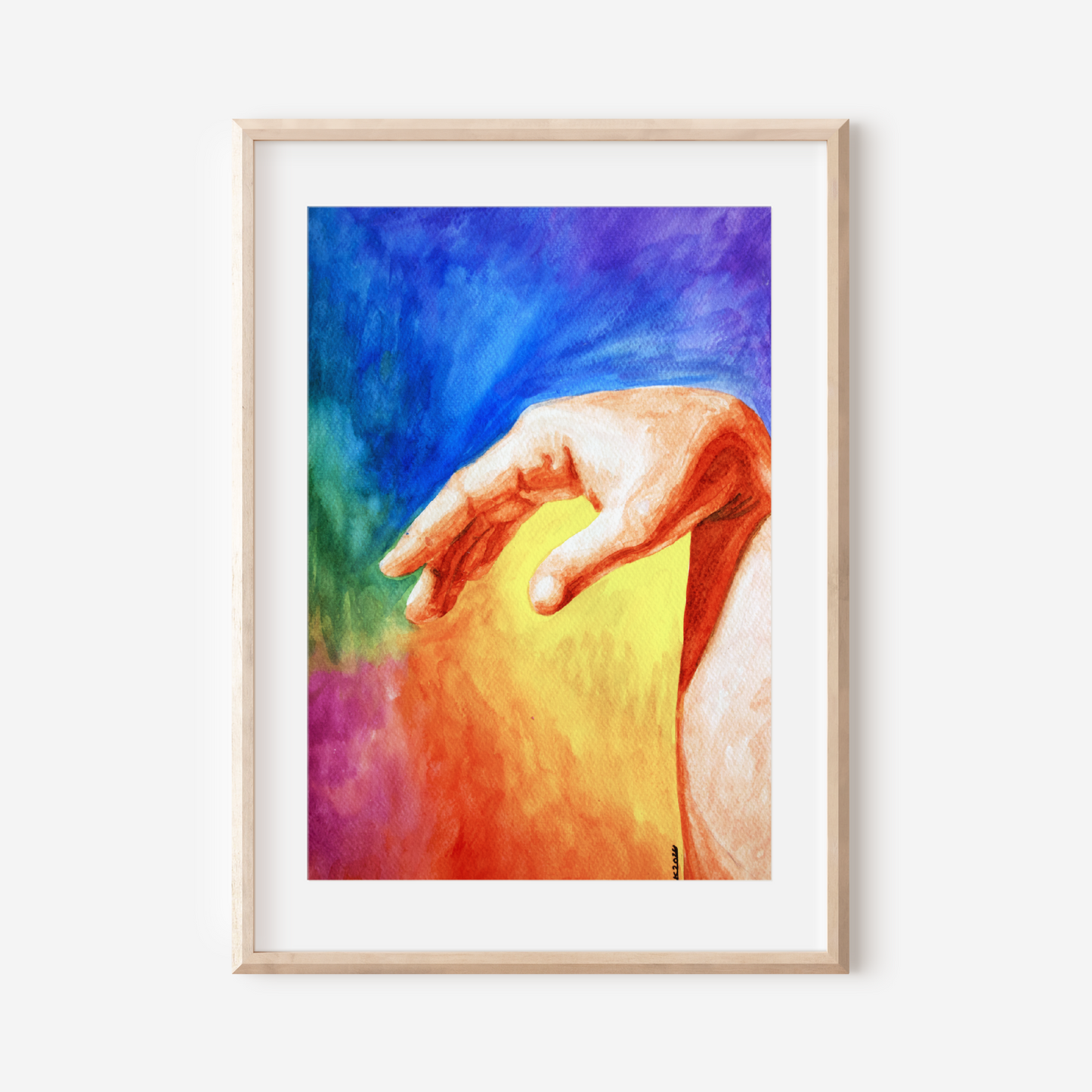 Framed artwork of a colorful hand reaching out on a white wall