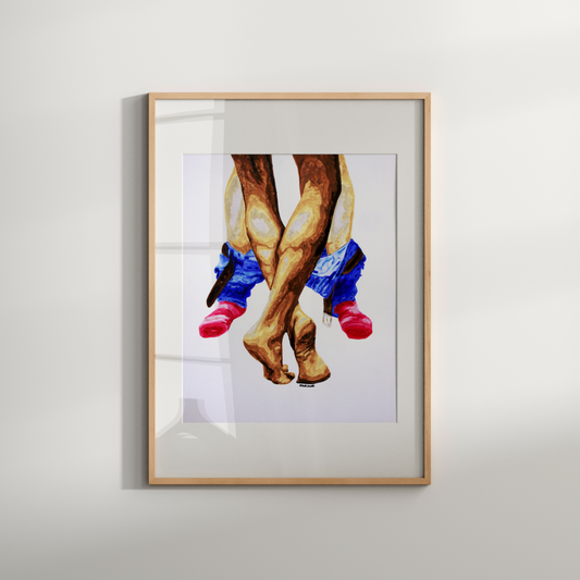 Framed artwork of a person wearing cowboy boots on a white wall