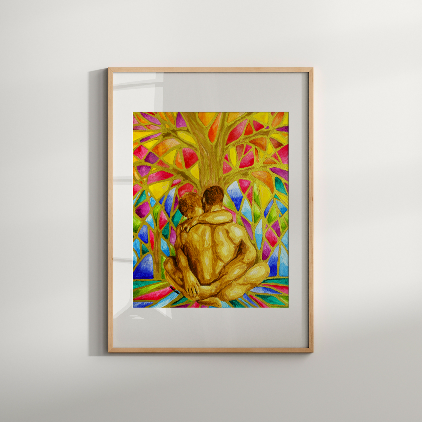 Framed artwork of two people embracing under a colorful tree on a white wall.