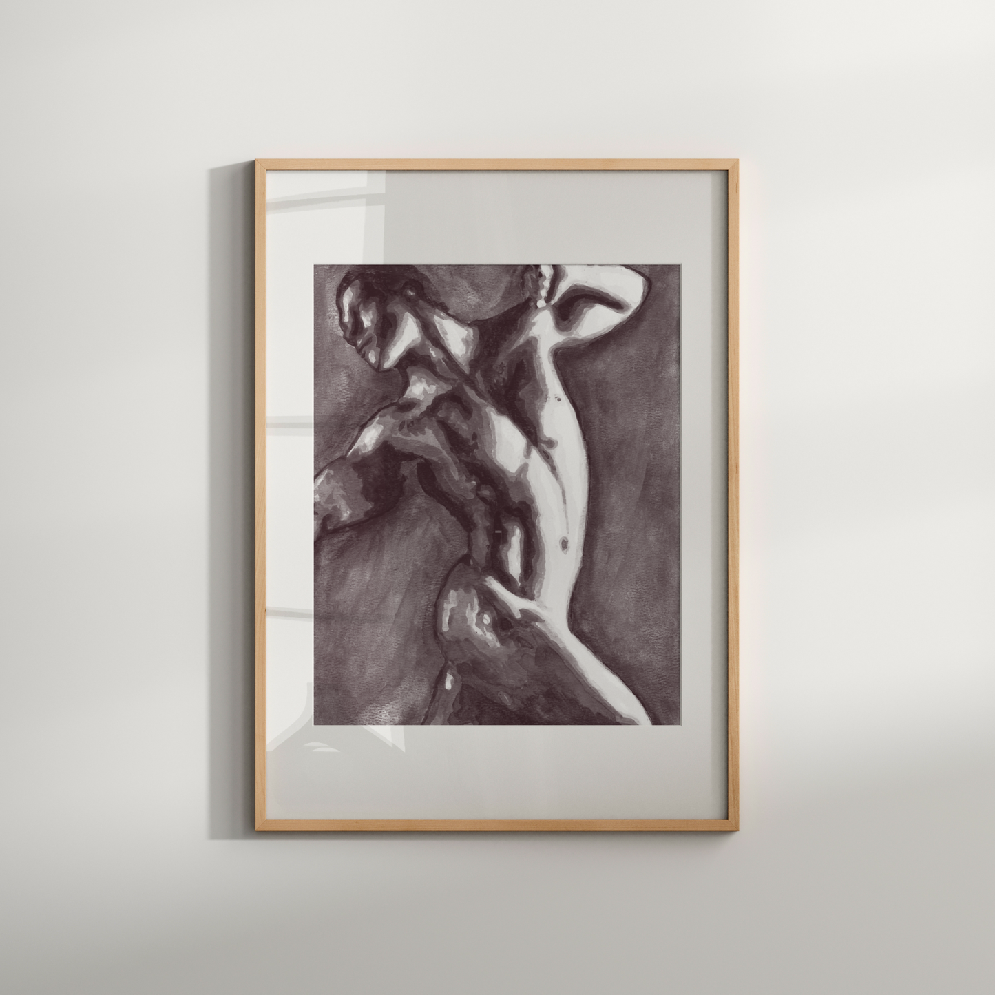 Framed artwork of a nude figure on a white wall