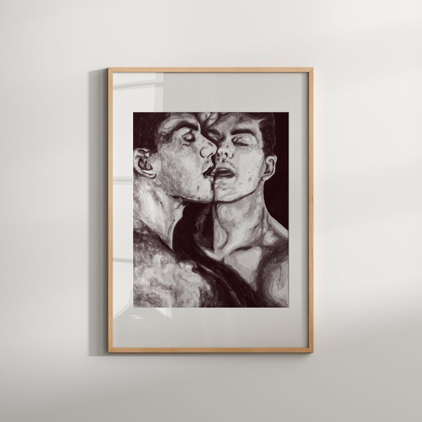 Framed black and white artwork of two figures on a light gray wall