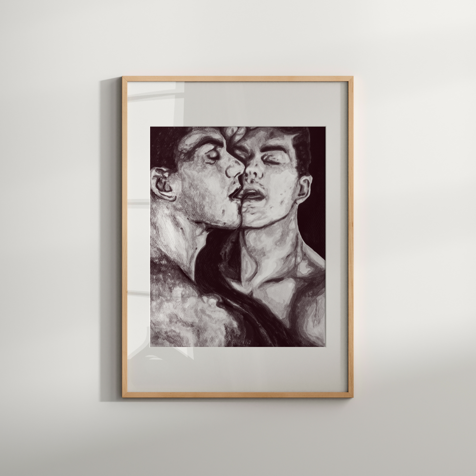 Framed black and white artwork of two figures on a light gray wall