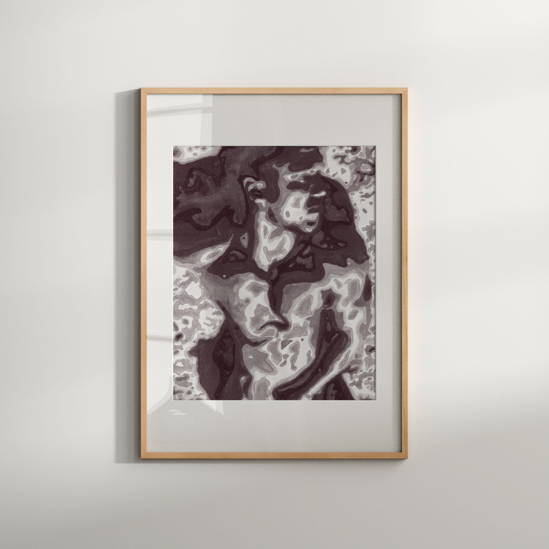 Framed abstract art piece on a white wall