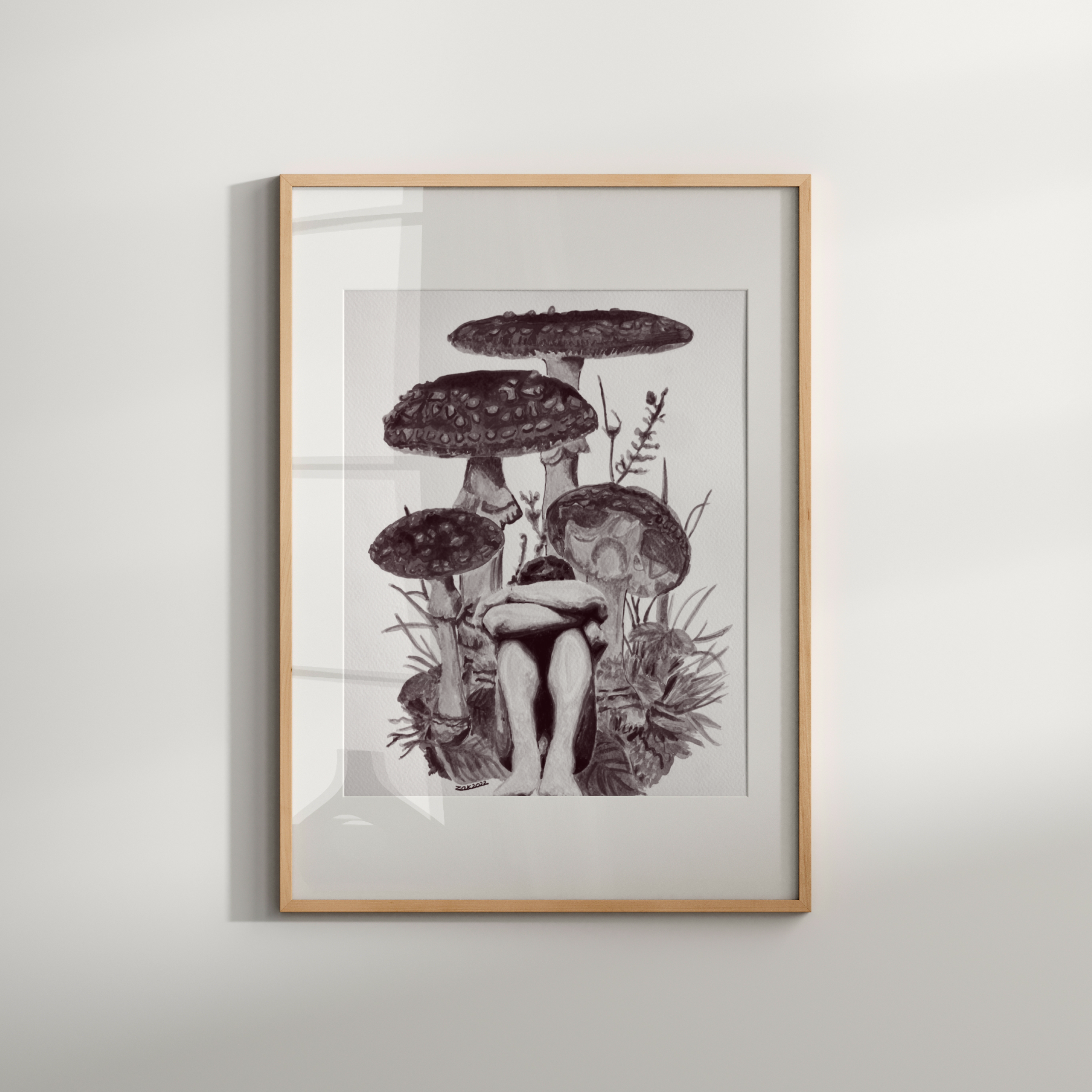 Framed artwork of a person surrounded by mushrooms on a white wall