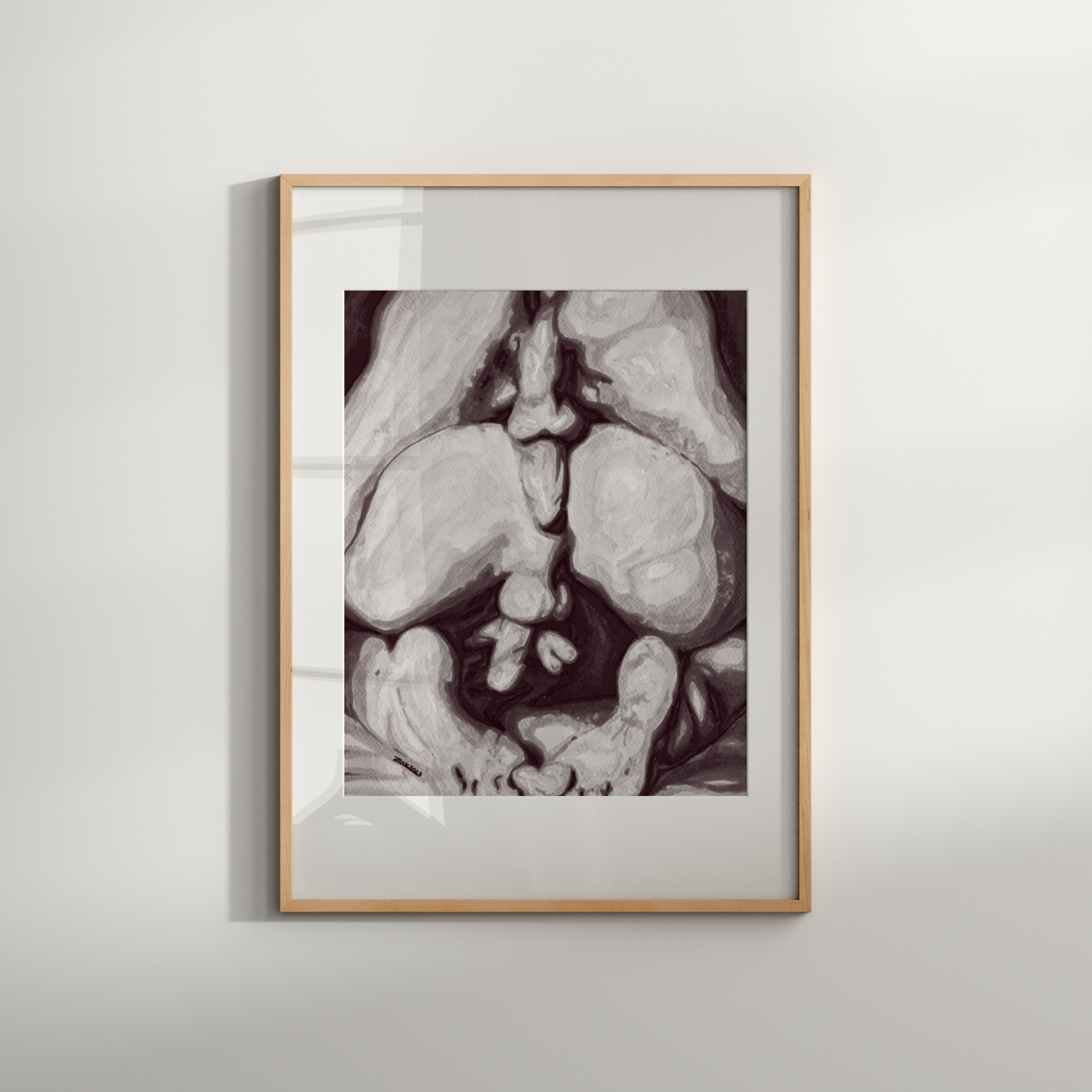 Framed black and white artwork on a light gray wall
