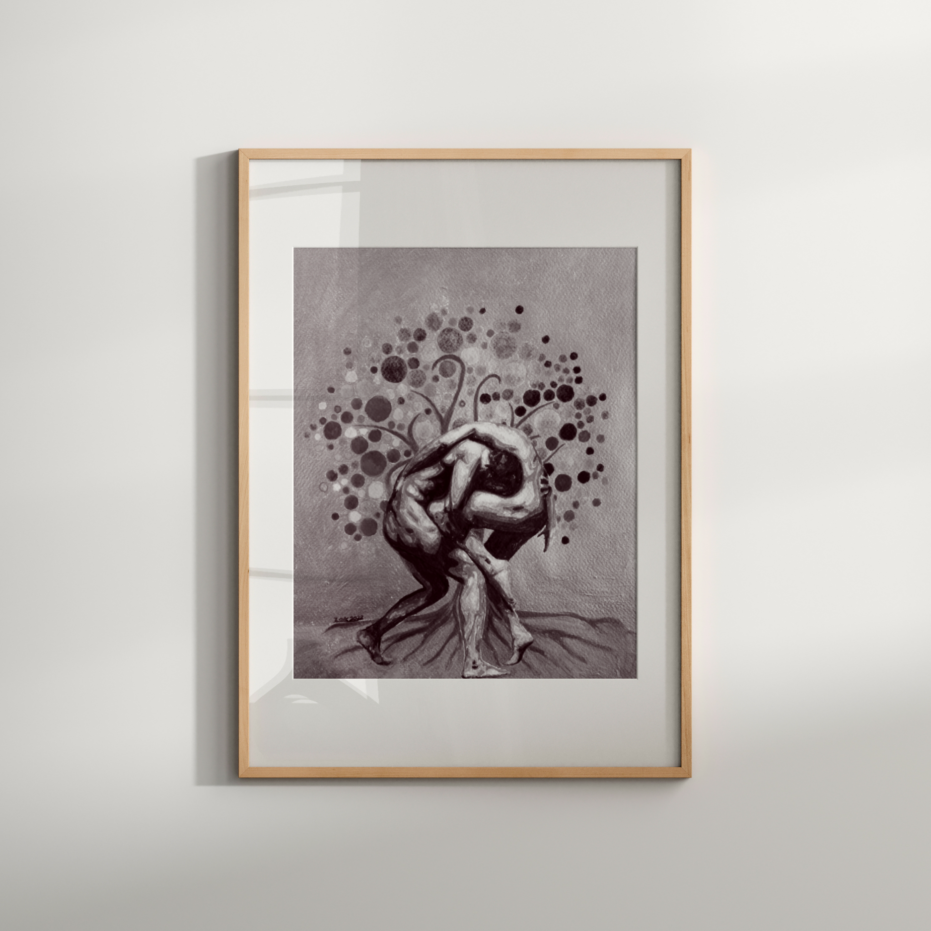 Framed artwork of a stylized figure with abstract elements on a white wall.