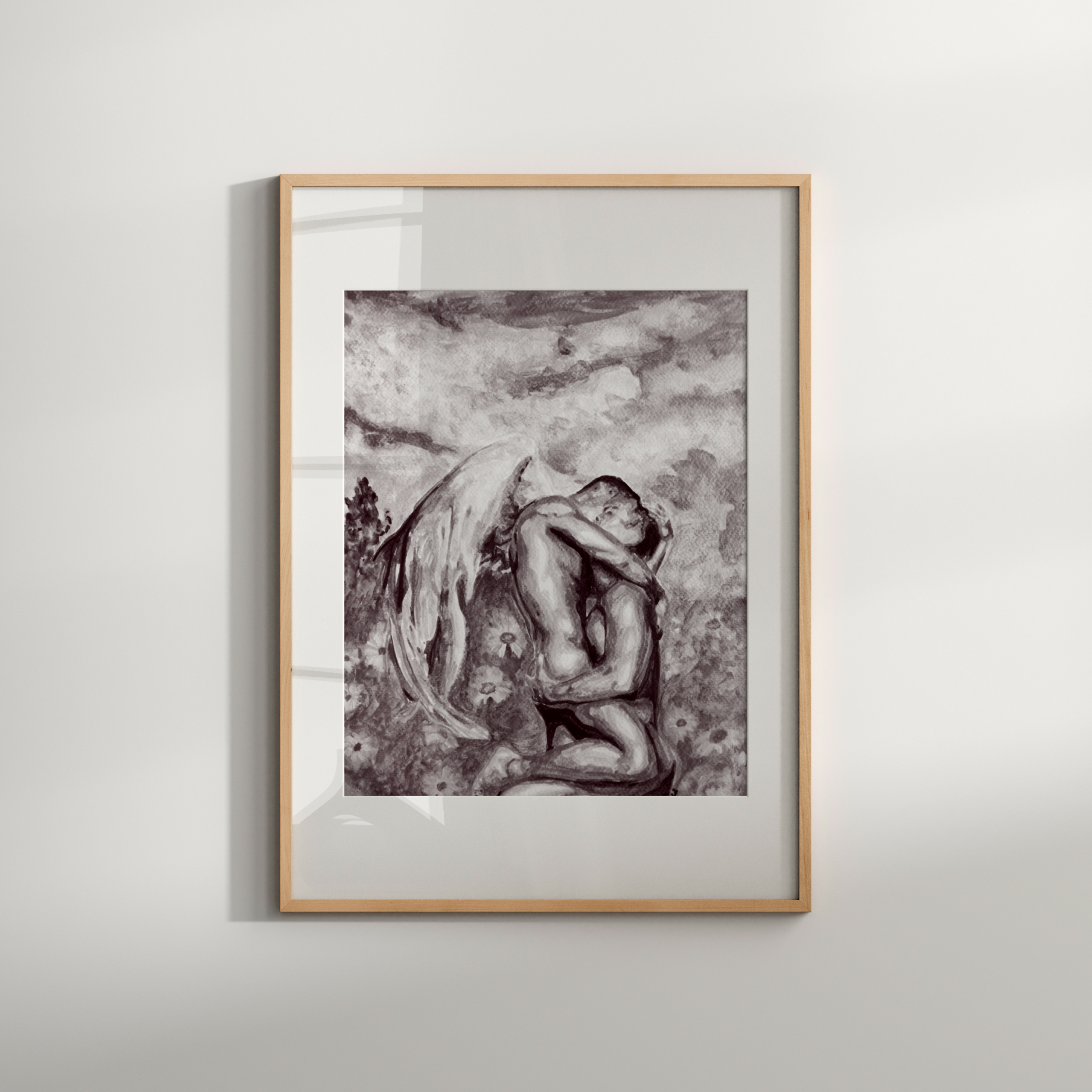 Framed black and white artwork of a nude figure on a plain wall