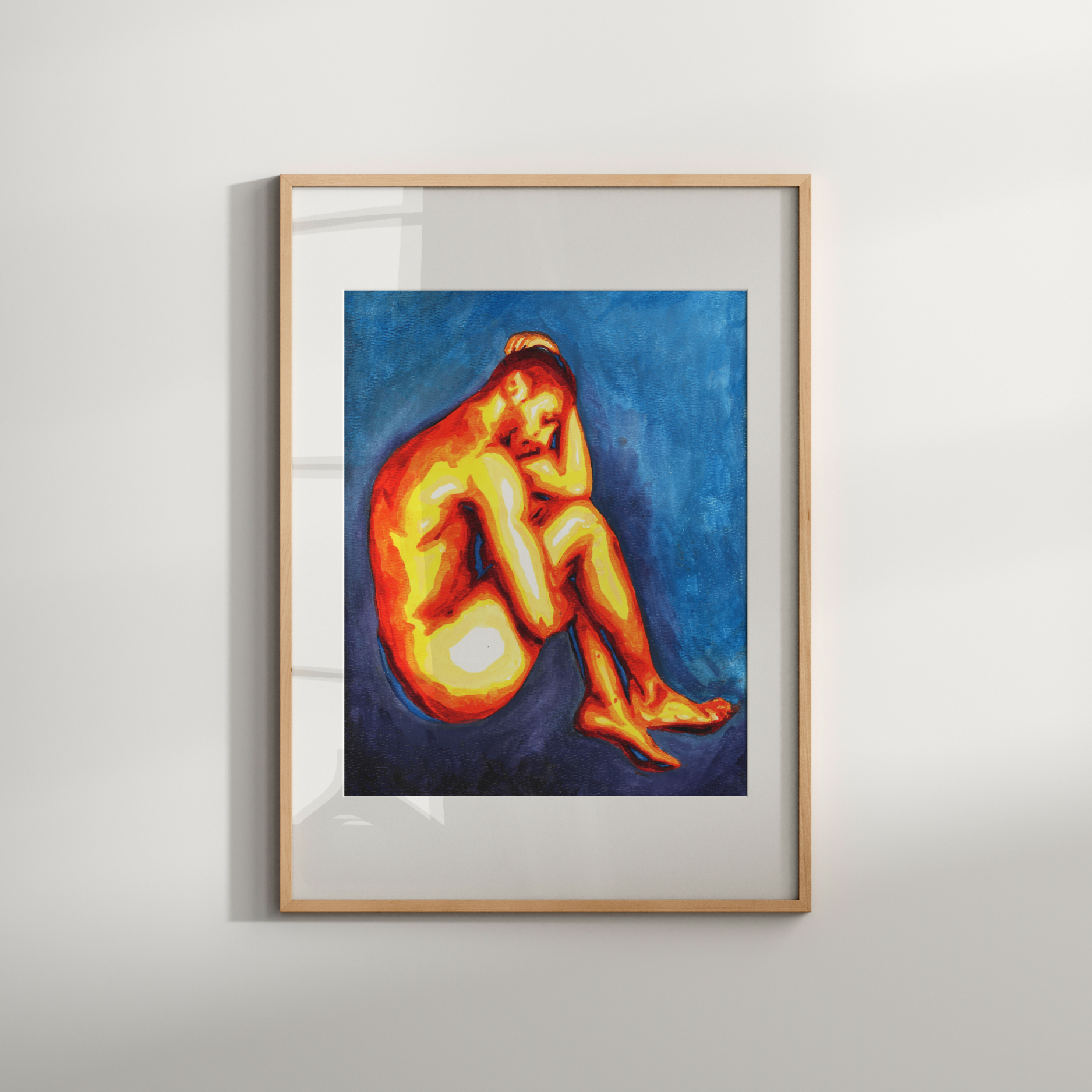 Framed artwork of a nude figure on a plain wall