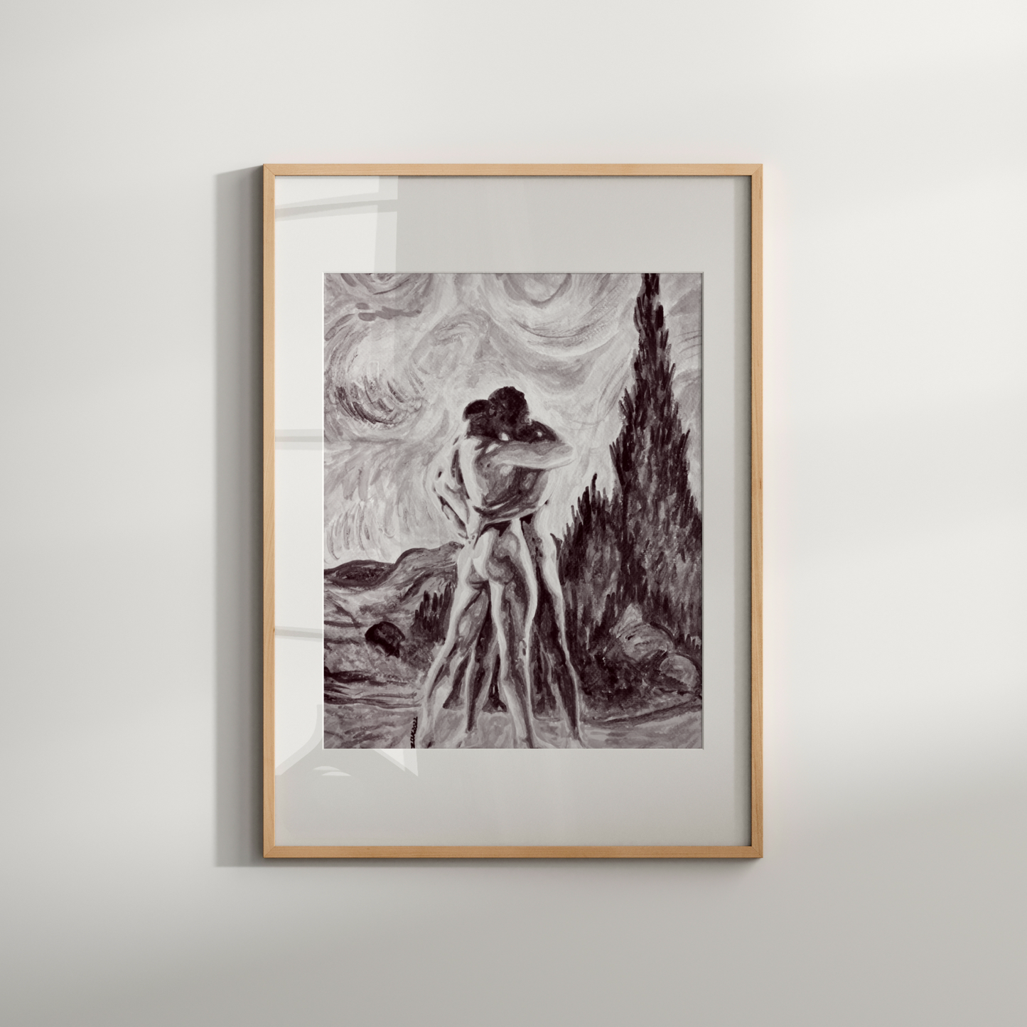 Framed black and white artwork of a woman in a landscape on a light gray wall.