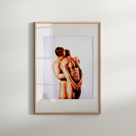 Framed artwork of two nude figures embracing on a white wall
