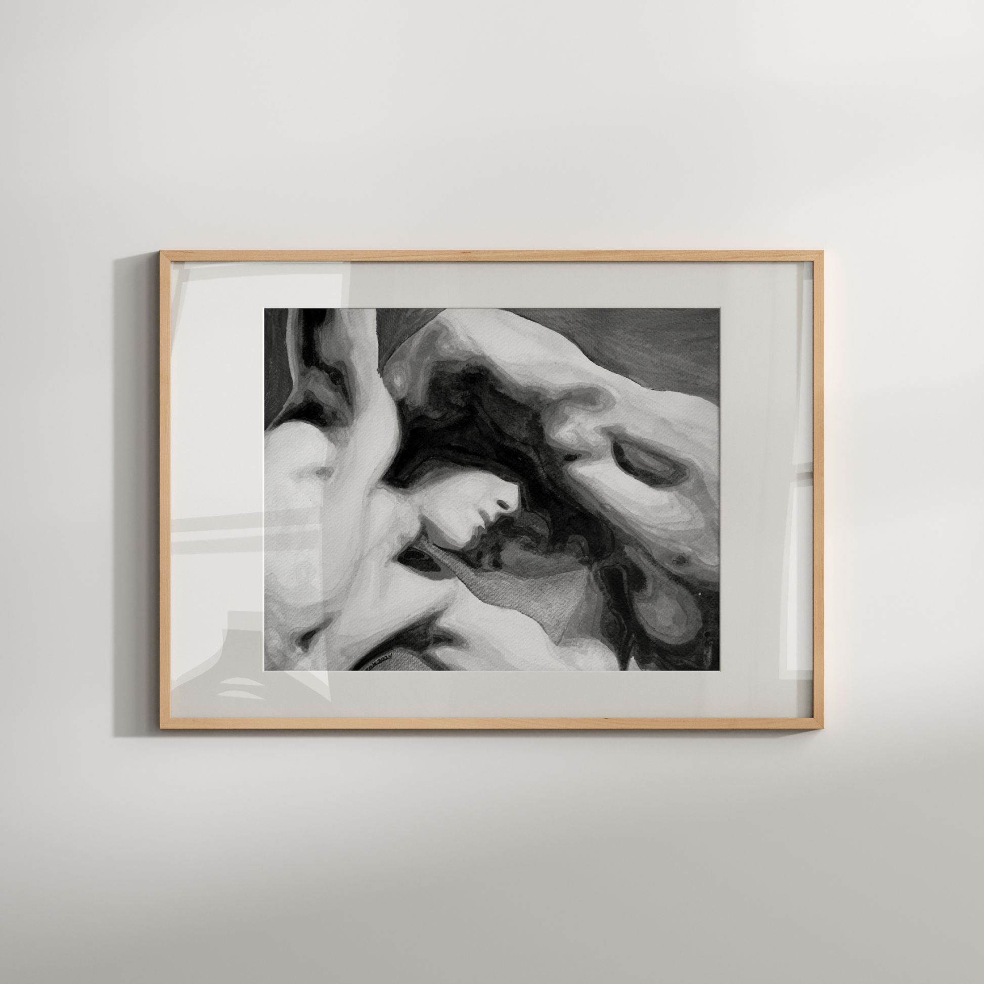 Framed black and white artwork of a classical sculpture on a light gray wall