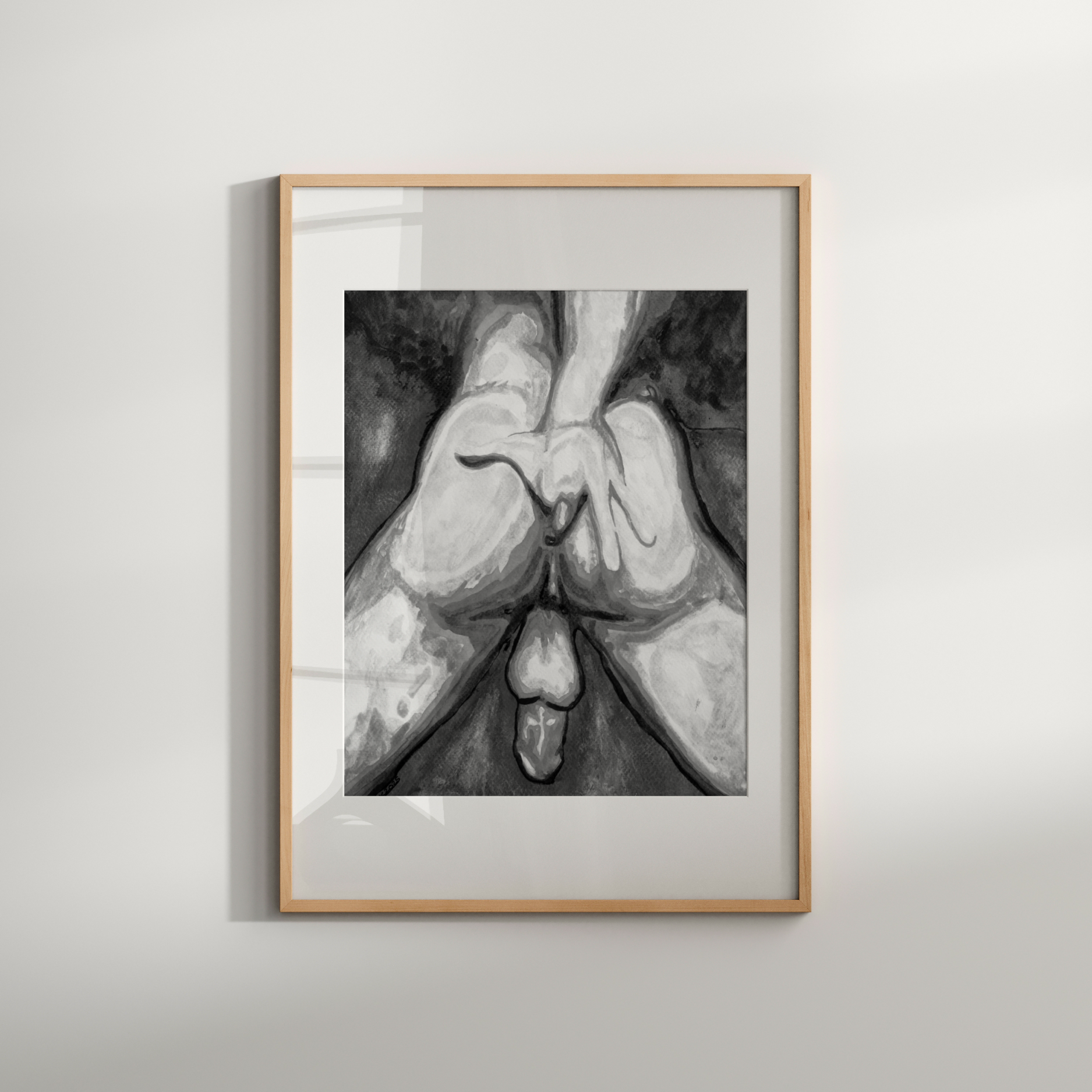 Framed black and white artwork of hands holding a heart on a light gray wall.